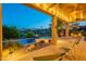 Inviting covered patio with seating, string lights, and a view of the pool and fire pit at 16333 E Crystal Point Dr, Fountain Hills, AZ 85268