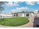 Manicured backyard with lush grass, a sparkling pool, and a covered patio at 1653 E Palmcroft Dr, Tempe, AZ 85282