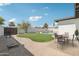 Inviting backyard features a refreshing pool, lush lawn, and outdoor dining area perfect for entertaining at 1653 E Palmcroft Dr, Tempe, AZ 85282