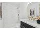 Bathroom featuring marble tile shower, modern vanity and gold hardware at 1653 E Palmcroft Dr, Tempe, AZ 85282