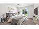 Modern bedroom boasts neutral tones, a sliding glass door and backyard views at 1653 E Palmcroft Dr, Tempe, AZ 85282