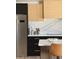 Sleek kitchen with modern appliances, stylish cabinets, and marble backsplash at 1653 E Palmcroft Dr, Tempe, AZ 85282