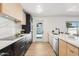 Modern kitchen with sleek countertops, two-toned cabinetry, and stainless steel appliances at 1653 E Palmcroft Dr, Tempe, AZ 85282