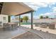 Spacious covered patio with dining and seating areas, overlooking a sparkling pool and green landscaping at 1653 E Palmcroft Dr, Tempe, AZ 85282