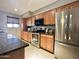 Well-equipped kitchen features stainless steel appliances, granite countertops, and wooden cabinetry at 1661 E Bishop Dr, Tempe, AZ 85282