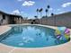Sparkling pool with ample space for outdoor relaxation and fun, complemented by swaying palm trees at 1661 E Bishop Dr, Tempe, AZ 85282