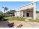 Stunning backyard with a pristine pool, lush lawn, covered patio, and cozy fire pit at 1680 S Arroyo Ln, Gilbert, AZ 85295