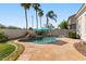 Backyard with a swimming pool and stone patio, perfect for outdoor relaxation and entertainment at 1680 S Arroyo Ln, Gilbert, AZ 85295