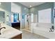 Bright bathroom featuring a soaking tub, glass enclosed shower, and double sink vanity with modern fixtures at 1680 S Arroyo Ln, Gilbert, AZ 85295