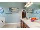 Bathroom features a double sink vanity, a large mirror, and decorative wall art at 1680 S Arroyo Ln, Gilbert, AZ 85295