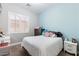 Comfortable bedroom with a plush bed, decorative pillows, side tables, and light-blocking shutters at 1680 S Arroyo Ln, Gilbert, AZ 85295