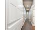 Long hallway with wood floors featuring a wall of built-in cabinets for extra storage at 1680 S Arroyo Ln, Gilbert, AZ 85295
