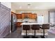 Modern kitchen boasts stainless steel appliances, wood cabinets, and a center island with bar stool seating at 1680 S Arroyo Ln, Gilbert, AZ 85295