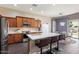 Well-lit kitchen with stainless steel appliances, an island with seating, and modern countertops at 1680 S Arroyo Ln, Gilbert, AZ 85295