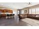 Spacious living area featuring hardwood floors, a large sofa, and seamlessly connected to the kitchen at 1680 S Arroyo Ln, Gilbert, AZ 85295