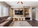 Well-lit living room featuring recessed lighting, a ceiling fan, wood floors, and a stone accent wall at 1680 S Arroyo Ln, Gilbert, AZ 85295