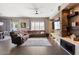 Spacious living room with recessed lighting, a ceiling fan, tile flooring, and a stone fireplace feature wall at 1680 S Arroyo Ln, Gilbert, AZ 85295