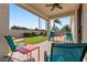 Charming patio with comfortable seating, vibrant lawn, and views of the sparkling pool area at 1680 S Arroyo Ln, Gilbert, AZ 85295