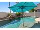 Inviting swimming pool with a rock waterfall, complemented by lush landscaping and a serene atmosphere at 1680 S Arroyo Ln, Gilbert, AZ 85295