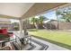 Backyard featuring a covered patio with nice lawn, and palm trees at 17820 W Charter Oak Rd, Surprise, AZ 85388