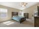 Spacious bedroom features carpet, ceiling fan, and plentiful natural light at 17820 W Charter Oak Rd, Surprise, AZ 85388