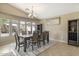 Cozy dining room offers a serene space for meals and gatherings under a elegant chandelier at 17820 W Charter Oak Rd, Surprise, AZ 85388