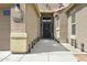 Inviting entryway featuring a covered porch and an elegant front door at 17820 W Charter Oak Rd, Surprise, AZ 85388