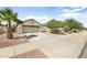 Beautiful home featuring desert landscaping, a two-car garage, and a well-maintained front yard at 17820 W Charter Oak Rd, Surprise, AZ 85388