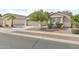 Inviting single-story home showcases desert landscaping, a spacious driveway, and a two-car garage at 17820 W Charter Oak Rd, Surprise, AZ 85388