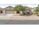 Charming single-story home with a well-manicured front yard, desert landscaping, and a spacious two-car garage at 17820 W Charter Oak Rd, Surprise, AZ 85388