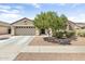 Charming single-story home with a well-manicured front yard, desert landscaping, and a spacious two-car garage at 17820 W Charter Oak Rd, Surprise, AZ 85388