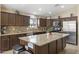 Gourmet kitchen features granite countertops, stainless steel appliances, and a large island at 17820 W Charter Oak Rd, Surprise, AZ 85388