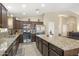 This chef's kitchen is equipped with modern appliances, granite counters, and custom cabinets at 17820 W Charter Oak Rd, Surprise, AZ 85388