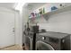 Convenient laundry room equipped with modern washer, dryer, and ample storage space at 17820 W Charter Oak Rd, Surprise, AZ 85388