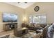 Bright and airy living room featuring a ceiling fan and comfortable seating at 17820 W Charter Oak Rd, Surprise, AZ 85388