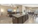 Open-concept living area with kitchen island overlooking comfortable seating and dining spaces at 17820 W Charter Oak Rd, Surprise, AZ 85388