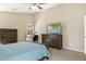 Comfortable main bedroom with a ceiling fan, work space, and a large dresser at 17820 W Charter Oak Rd, Surprise, AZ 85388