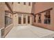 Spacious outdoor patio with multiple glass doors and windows to an indoor living area at 18121 W Las Cruces Dr, Goodyear, AZ 85338