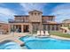 Stunning backyard with a pool, hot tub, grassy area, and access to the home's outdoor living spaces at 18121 W Las Cruces Dr, Goodyear, AZ 85338