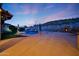 Spacious backyard with an outdoor fireplace, pool, seating, and desert views, perfect for entertaining and relaxing at 18121 W Las Cruces Dr, Goodyear, AZ 85338