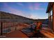 Relaxing balcony view with chairs, striking patterned outdoor rug, and breathtaking mountain views at 18121 W Las Cruces Dr, Goodyear, AZ 85338