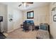 A well-appointed bedroom featuring two monitors, a comfy chair, and a macrame wall hanging at 18121 W Las Cruces Dr, Goodyear, AZ 85338