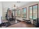 Dedicated exercise room with weightlifting equipment, mirrored wall, and plantation shutters with a peek at the pool at 18121 W Las Cruces Dr, Goodyear, AZ 85338