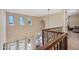 Foyer with soaring ceilings, wood railing, and natural light at 18121 W Las Cruces Dr, Goodyear, AZ 85338