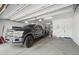 Spacious garage featuring a large truck and ample storage space. Includes an automatic garage door opener at 18121 W Las Cruces Dr, Goodyear, AZ 85338