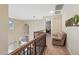 Hallway with wood railing, overlooking the living room at 18121 W Las Cruces Dr, Goodyear, AZ 85338