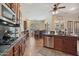 An open, modern kitchen with granite counters, stainless appliances, and island seating at 18121 W Las Cruces Dr, Goodyear, AZ 85338