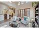 Bright living room with vaulted ceilings, large windows, and neutral furniture at 18121 W Las Cruces Dr, Goodyear, AZ 85338