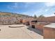 Outdoor kitchen featuring a built-in grill, countertop space, and fireplace, perfect for entertaining at 18121 W Las Cruces Dr, Goodyear, AZ 85338