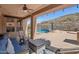 Relaxing covered patio with ceiling fans, comfortable seating, and a view of the sparkling pool at 18121 W Las Cruces Dr, Goodyear, AZ 85338